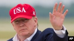 President Donald Trump waves as he steps off Air Force One after arriving, June 7, 2019, at Andrews Air Force Base, Maryland.