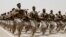 FILE - Saudi soldiers march during a military drill in Hafar Al-Batin, Saudi Arabia. 