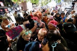 FILE - People protest in support of pop star Britney Spears on the day of a conservatorship case hearing at Stanley Mosk Courthouse in Los Angeles, Calif., June 23, 2021.