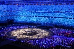 FILE - The Olympic Stadium is lighted up as athletes take part in the athletes' parade during the closing ceremony, Aug. 8, 2021.