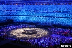 FILE - The Olympic Stadium is lighted up as athletes take part in the athletes' parade during the closing ceremony, Aug. 8, 2021.