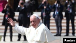 Pope Francis waves as he leaves at the end of a Holy Mass to mark the feast of Divine Mercy at the Vatican, April 8, 2018. 