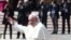 Pope Francis waves as he leaves at the end of a Holy Mass to mark the feast of Divine Mercy at the Vatican, April 8, 2018. 
