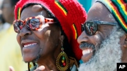FILE - Deborah Smith and her husband, Kuma, watch festivities at a Juneteenth celebration at Leimert Park in the Crenshaw District of Los Angeles, June 19, 2010.