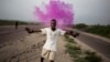 A supporter of Democratic Republic of Congo opposition leader Martin Fayulu reacts after police fire teargas in Kinshasa, Dec. 19, 2018.