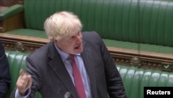 FILE - Britain's Prime Minister Boris Johnson gestures as he speaks during the weekly question time debate in Parliament in London, Sept. 30, 2020, in this screen grab taken from video.