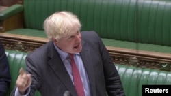 Britain's Prime Minister Boris Johnson gestures as he speaks during the weekly question time debate in Parliament in London, Sept. 30, 2020, in this screen grab taken from video. 