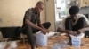 FILE - Workers pack plastic sachets filled with drinkable water for delivery in Dakar, on August 23, 2023