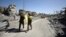 Fighters of Syrian Democratic Forces walk along a street in Raqqa, Syria, Oct. 17, 2017. 