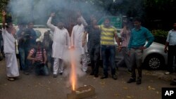 Congress party supporters light crackers outside the residence of their leader Rahul Gandhi as they celebrate his return from holidays in New Delhi, India, April 16, 2015.