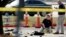 FBI crime scene investigators document the area around two deceased gunmen and their vehicle outside the Curtis Culwell Center in Garland, Texas, May 4, 2015.  