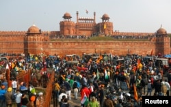 Farmers gather in front of the historic Red Fort during a protest against farm laws introduced by the government, in Delhi, India, Jan. 26, 2021.