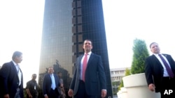 The eldesr son of U.S. President Donald Trump, Donald Trump Jr., center, stands in front of Trump Towers after its inauguration in Pune, India, Feb. 21, 2018. 