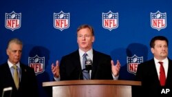 El comisionado de la NFL, Roger Goodell (centro), flanqueado por el presidente de los Steelers de Pittsburgh, Art Rooney II (izquierda), y el propietario de los Cardinals de Arizona, Michael Bidwill, durante la conferencia de prensa donde anunció el acuerdo entre los dueños de equipos de la liga sobre la nueva regla que requiere a los jugadores ponerse de pie durante el himno nacional o permanecer en los camerinos. Mayo 23 de 2018.