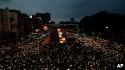 Pro-democracy activists wave mobile phones with lights during a demonstration at Kaset intersection, suburbs of Bangkok, Thailand, on Oct. 19, 2020. 