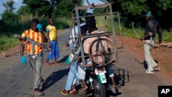 FILE - Armed anti-balaka militiamen guard a checkpoint about 60 kilometers north of Bangui, Central African Republic, June 2014.