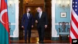 Secretary of State Mike Pompeo, right, walks out with with Armenia's Foreign Minister Zohrab Mnatsakanyan to face reporters, prior to holding talks at the State Department in Washington, Oct. 23, 2020. 