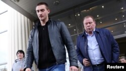 Actor Pavel Ustinov and lawyer Anatoly Kucherena leave a court hearing in Moscow, Russia, Sept. 30, 2019. 