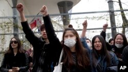 Demonstrators from the Asian community protest outside Paris' 19th district's police station, March 28, 2017.