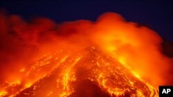 FILE - Lava gushes from the Mt. Etna volcano near Catania, southern Italy, Feb. 16, 2021. 