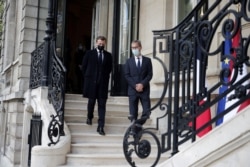 French President Emmanuel Macron speaks with Deputy Head of Mission at the Austrian Embassy Wolfgang Wagner after signing a condolence book for victims of the Vienna shooting, in Paris, France, Nov. 3, 2020. (Christophe Petit Tesson/Pool via Reuters)