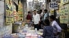 FILE - Students purchase books at a wholesale market in Prayagraj, India, June 20, 2024, as they prepare to study in hopes of landing the security of a government job. 