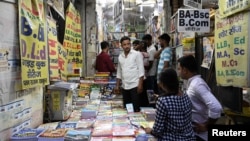 FILE - Students purchase books at a wholesale market in Prayagraj, India, June 20, 2024, as they prepare to study in hopes of landing the security of a government job. 