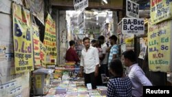 Students purchase books at a wholesale books market in Prayagraj, India, June 20, 2024.