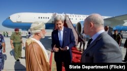 Menlu AS John Kerry berbincang dengan Dubes AS Oman Marc Sievers (kanan), dan Menlu Oman Yusuf bin Alawi di bandara Internasional Muscar di Oman seusai pertemuan bilateral kedua negara. (15/11). 