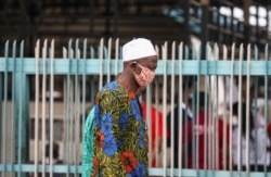 A man wearing a protective face mask is seen on the first day of the easing of coronavirus lockdown measures, in Lagos, Nigeria, May 4, 2020.