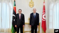 Tunisian President Kais Saied, right, and Libyan Prime Minister Abdul Hamid Dbeibah pose for a photo in Tunis, Tunisia, Sept. 9, 2021. 