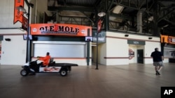 A Baltimore Orioles employee drives through the stadium concourse before the Chicago White Sox and Baltimore Orioles baseball game, in Baltimore, April 29, 2015.