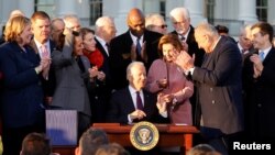 U.S. President Joe Biden reacts as he signs the "Infrastructure Investment and Jobs Act", on the South Lawn at the White House in Washington, U.S., November 15, 2021. (REUTERS/Jonathan Ernst)