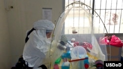 U.S. Navy Lt. Jose Garcia inactivates the Ebola virus in each specimen to render the virus safe for further analysis at a Naval Medical Research Center mobile laboratory on Bushrod Island, Liberia,
(U.S. Army Africa/Navy Chief Petty Officer Jerrold Diederich)
