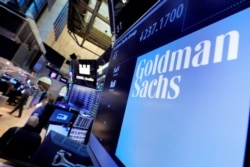 FILE - The logo for Goldman Sachs appears above a trading post on the floor of the New York Stock Exchange, Dec. 13, 2016.