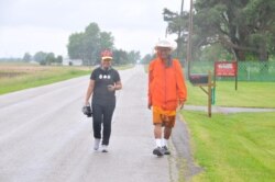 Warangkana Chomchuen walks with a Thai monk on a location shoot. (Pinitkarn Tulachom/VOA Thai)