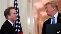 President Donald Trump shakes hands with Judge Brett Kavanaugh his Supreme Court nominee, in the East Room of the White House, July 9, 2018, in Washington. 