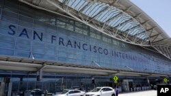 FILE - Vehicles wait outside the international terminal at San Francisco International Airport in San Francisco. 