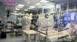 FILE - Medical staff in protective suits treat coronavirus patients in an intensive care unit at the Cremona hospital in northern Italy, in this still image taken from a video, March 5, 2020.