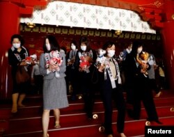 Owners of Sony's robotic dog 'Aibo' attend a ritual ceremony Sichi-Go-San, which is usually held for praying for children's health and wellbeing, in Tokyo