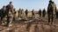 FILE - Kurdish Peshmerga forces inspect a site in Hardan village in northern Iraq where Islamic State fighters allegedly executed people from the Yazidi sect captured when they swept through the area in August.