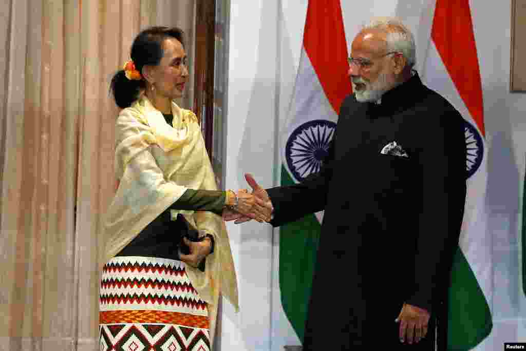 Myanmar's State Counsellor Aung San Suu Kyi shakes hands with India's Prime Minister Narendra Modi during a photo opportunity ahead of their meeting at Hyderabad House in New Delhi, India, January 24, 2018. REUTERS/Cathal McNaughton - RC1C5C09F740