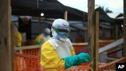 FILE - An Ebola health worker is seen at a treatment center in Beni, Eastern Congo, April 16, 2019. 