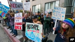 Opponents of the Dakota Access pipeline join protesters around the country, in response to the Army Corps of Engineers clearing the way for completion of the disputed $3.8 billion project to carry North Dakota oil to Illinois, outside the Army's offices in Los Angeles, Feb. 8, 2017. 