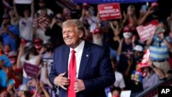 President Donald Trump stands on stage after speaking at a campaign rally at Smith Reynolds Airport, Tuesday, Sept. 8, 2020, in Winston-Salem, N.C. (AP Photo/Evan Vucci)