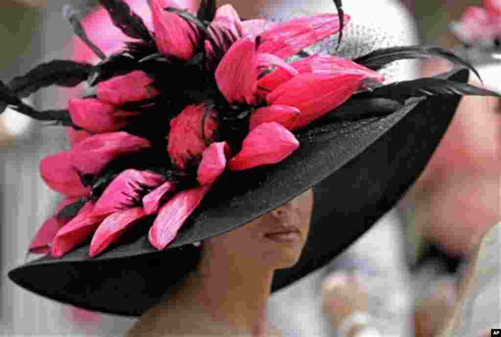 Rachel Ford, from Louisville, Ky., waits for the running of the 138th running of the Kentucky Oaks horse race at Churchill Downs Friday, May 4, 2012, in Louisville, Ky. (AP Photo/Mark Humphrey)
