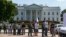 Demonstrators are lined up outside the White House in Washington, Aug. 28, 2014, as they are being arrested during a protest on immigration reform.