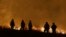 Firefighters stand guard as flames from the Butte Fire approach a containment line in San Andreas, California, Sept. 12, 2015.