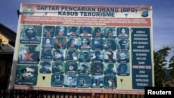 A police billboard shows a list of individuals, including the country's top militant Santoso (top L), wanted in relation with terrorism cases in Poso, Indonesia's Central Sulawesi province, Dec. 19, 2015. 