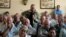 FILE - A farmer addresses a meeting of white commercial farmers in Harare, Zimbabwe, Feb. 5, 2010.